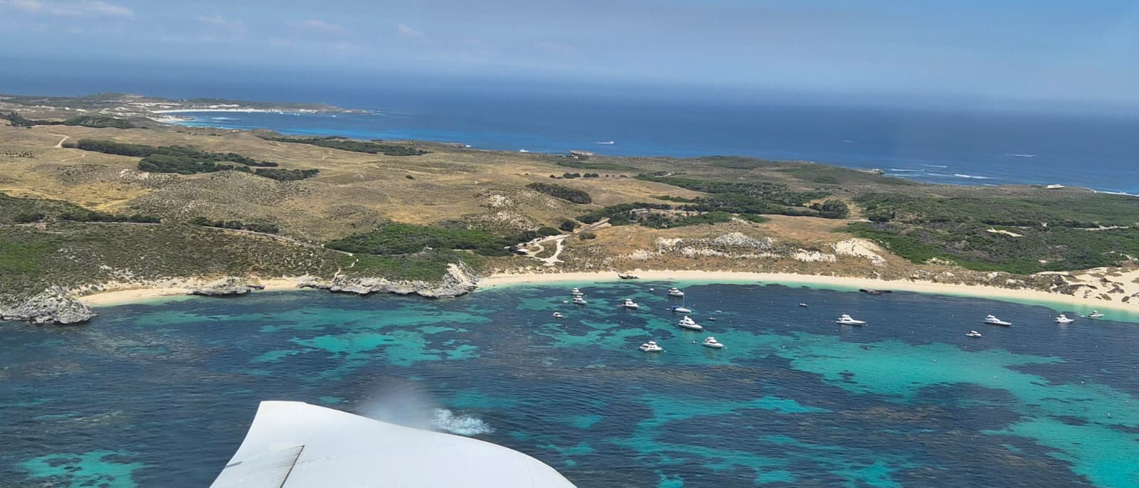 Aerial coastline view from aircraft wing